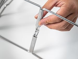 Slide the locking pins on both sides of the stand downward to lock it in place.